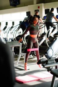 Woman using resistance band in gym