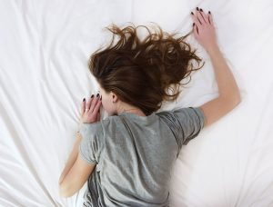 Woman lying on bed sleeping